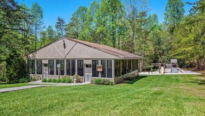 A single-story building with a gabled roof, large windows, and a covered outdoor area with a play structure. - Mountain Views Indoor Pool Hot Tub Sleeps 4 (Gatlinburg)