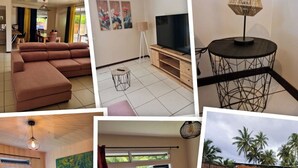 Una habitación de hotel con cama, sofá, televisión, comedor y piscina.