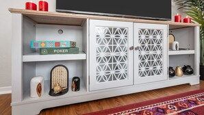 A white entertainment unit with a flat-screen TV, decorative items, and a patterned rug. - Passionate 2BD: Where Your HEART Feels at HOME! (Fort Worth)