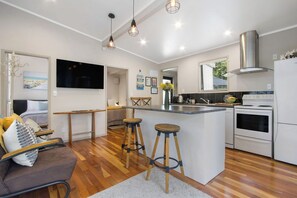 Fridge, microwave, oven, stovetop - Te Mahana Cottage - pool & private spa, beachfront (Waihi Beach)