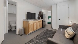 A modern apartment with a kitchen, a living area, and a bathroom. - Private Suite, Sleep and Bike- Seconds 2  trail! Private Basement Apartment. (Bella Vista)