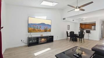 Smart-tv, eldstad och ett bordtennisbord