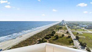 A coastal view with a beach, road, and buildings. - Bay Watch 1441 (North Myrtle Beach)