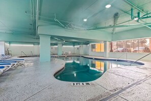 Ein Hallenbad mit klarem Wasser, einer Markierung der Wassertiefe von etwa 107 Zentimetern und Blick auf geparkte Autos drauĂen.