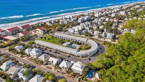 An aerial view of a coastal residential area with houses, a large building with a swimming pool, and a beach in the background. - Prime 30A Location/EZ Beach Access/Quiet Pool/Fast Wifi  (Santa Rosa Beach)