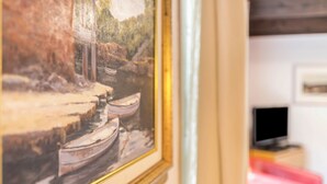 A framed painting of boats on a river. - Apartment 'Atlanta 202' with Private Terrace, Private Garden and Wi-Fi (Pellworm)