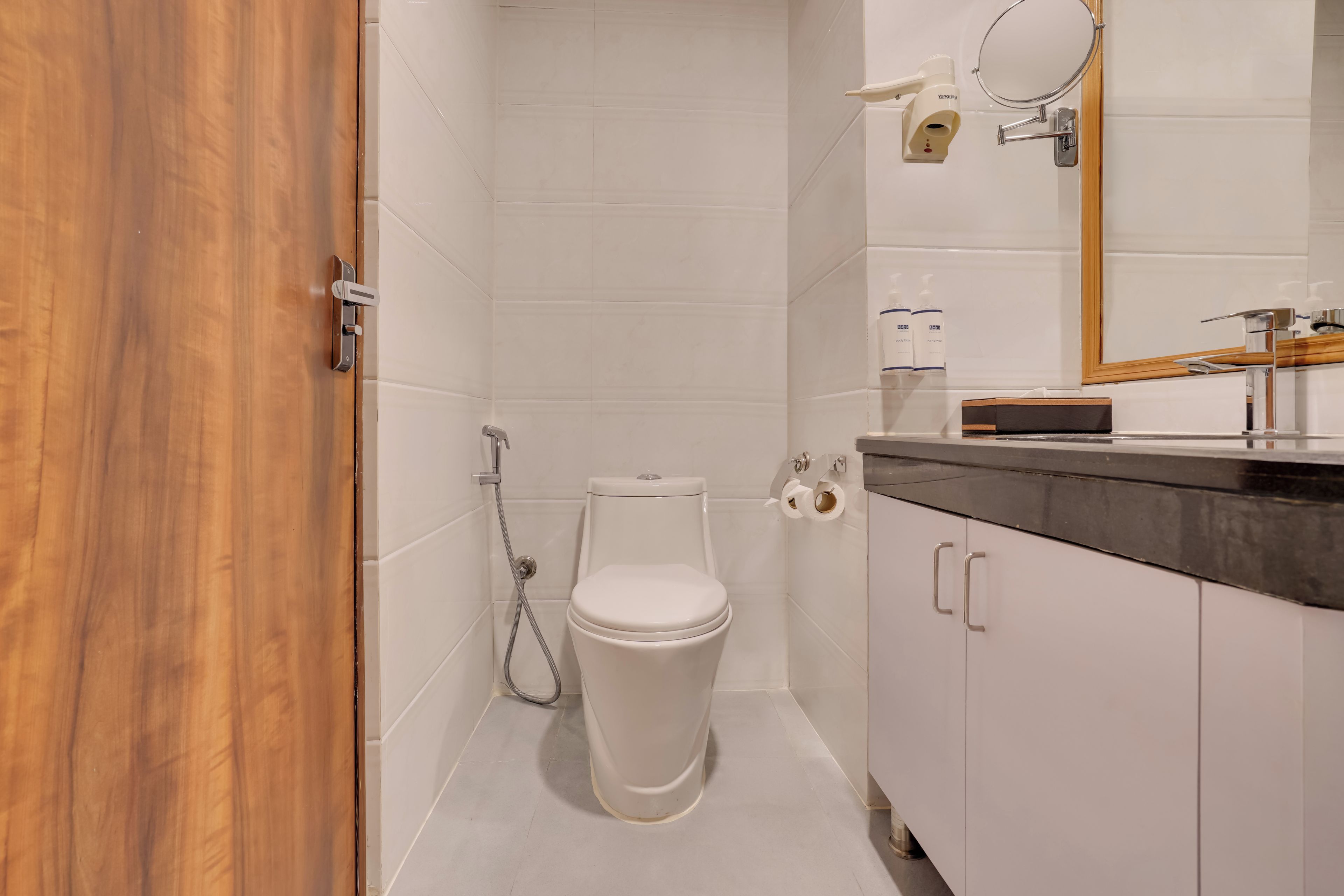 A modern bathroom with a toilet, shower, and vanity.