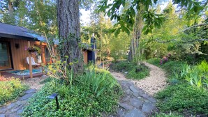 A wooden cabin with a stone pathway leading to a porch.