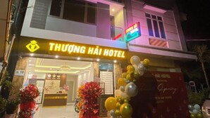 A hotel with a sign reading "THUONG HAI HOTEL" and a neon sign indicating "Opening Soon". - Thuong Hai Hotel - by Bay Luxury (Hanoi)
