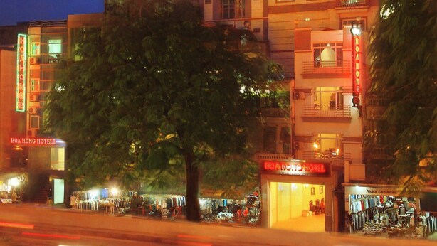 A multi-story hotel with illuminated signage, including "KHACH SAN HOA HONG" and "HOAHONG HOTEL" on the facade. - Hoa Hong 1 Hotel - by Bay Luxury (Hanoi)