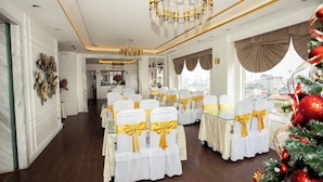 A hotel room with a large chandelier, a view of the city, and a Christmas tree. - Hoa Hong 1 Hotel - by Bay Luxury (Hanoi)