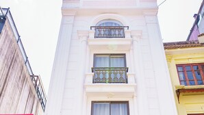 The Sapa Crown Hotel with a prominent sign, a balcony, and a glass entrance. - Sapa Crown Hotel (Sa Pa)