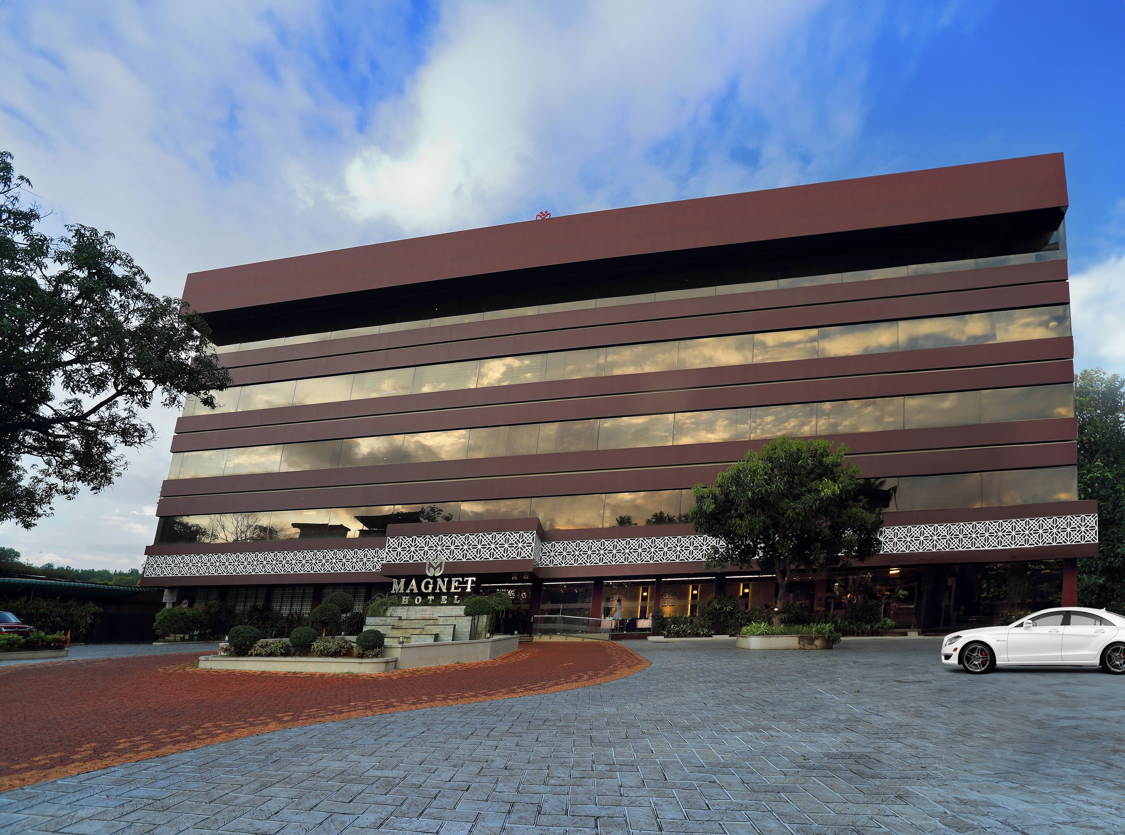 A modern hotel building with a flat roof and horizontal lines.