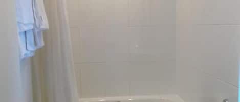 A bathroom with a bathtub, toilet, and sink.