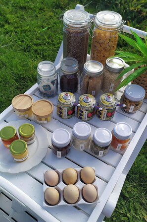 A variety of food items and condiments arranged on a white tray outdoors. - Taranaki Creekside TUI by Tiny Away (Midhirst)