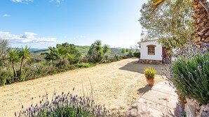 A white building with a paved path leading to it, surrounded by greenery and a clear sky. - Holiday Home 'Casa Rural Villa Campito' with Mountain View, Private Pool and Wi-Fi (Antequera)
