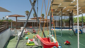 A playground with swings, slides, and climbing structures. - Apartment 'Golden Sun Two-bedroom Apt 4' with Sea View, Shared Pool and Wi-Fi (Tigaki 0)