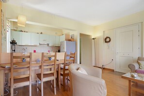 A compact living space with a kitchen, dining area, and a seating area.