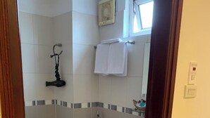 A small, clean bathroom with a toilet, sink, and shower area. - Love Hotel Hoang Mai HN- by Bay Luxury (Hanoi)