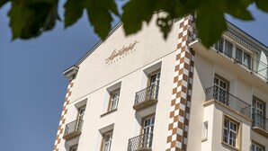 A building with a checkered facade and balconies. - Wellness apartment with pool and terrace (Lenzerheide/Lai)