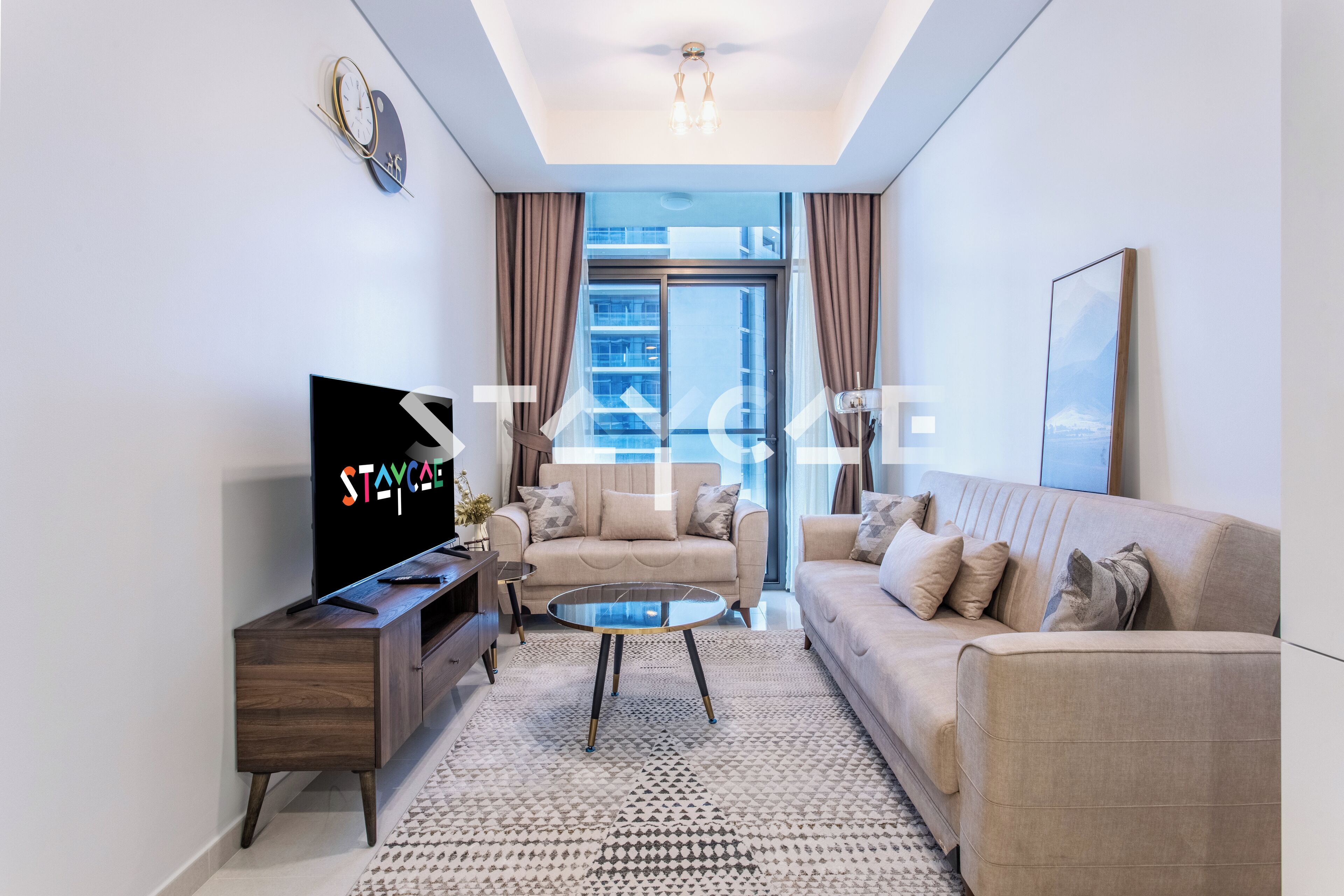 A modern living room with a sofa, coffee table, TV, and a large window with curtains.
