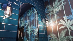 A bathroom with blue tiles and a tropical leaf pattern. - Fairview Apt B - 2BR Gem in West Bridgford Centre (West Bridgford Nottingham)
