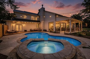A house with a swimming pool, outdoor seating, and a covered patio area.