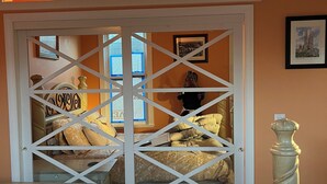 A bedroom with a bed, a nightstand, a lamp, and a window. - “Lovely” Bungalow near downtown Quincy!  (Quincy)