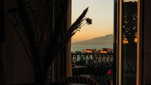 A balcony with a view of a distant mountain range and a body of water. - Mermaids' Dream Sorrento (Sorrento)