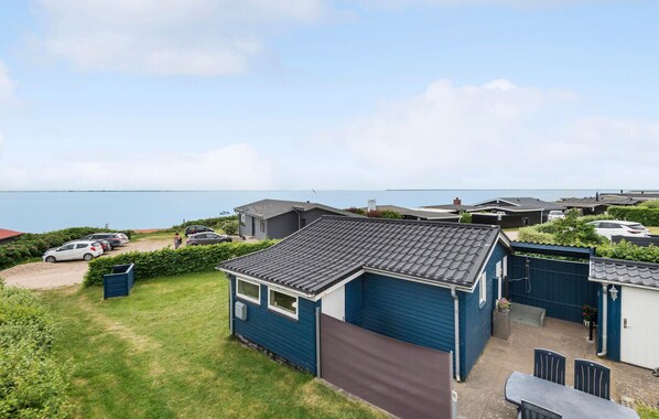 A seaside caravan with a covered patio and a view of the sea.