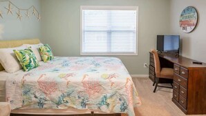 A bedroom with a bed, a desk, and a window. - Marsh Girl Suite: St. James Studio - Beach Club, Pool & Marina (Southport)