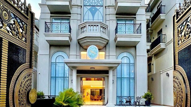 A grand building with a central entrance, multiple balconies, and decorative ironwork. - Sabina Luxury Boutique Hotel & Villa (Ho Chi Minh City)