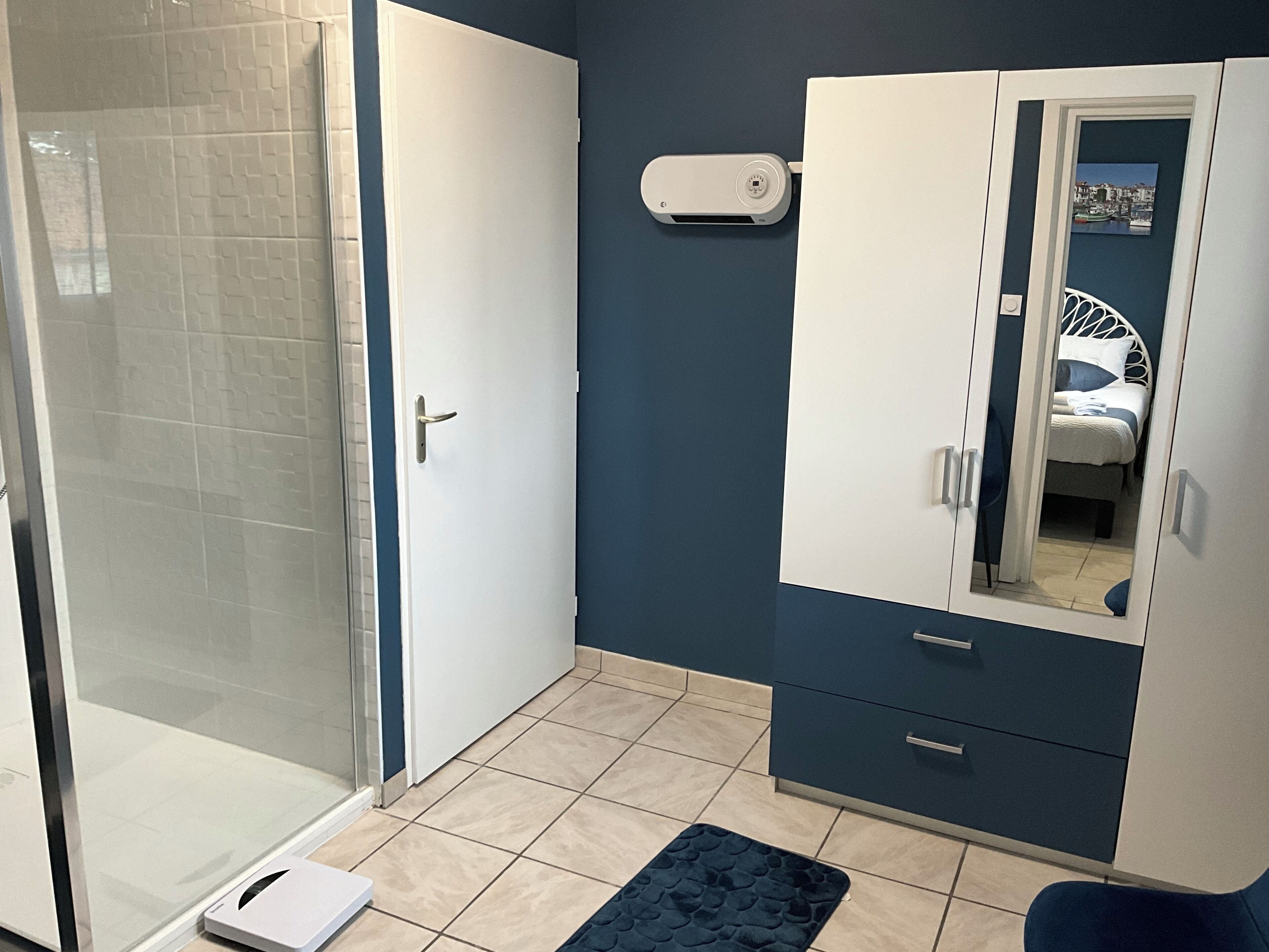 A bathroom with a shower, a toilet, and a sink.