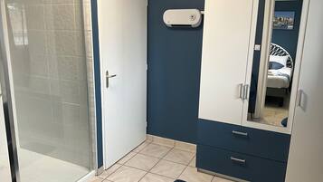 A bathroom with a shower, a toilet, and a sink.