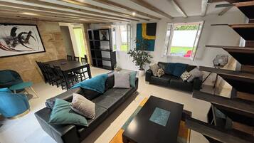 Télévision, cheminée, baby-foot, livres