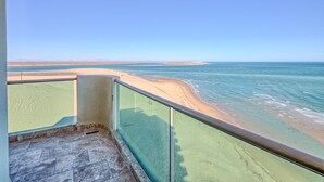 A balcony with a clear view of a beach and ocean. - Ocean Wrap Around Oceanfront Balcony at Tessoro (Las Conchas)