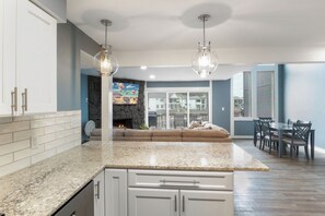 Enjoy meals in the kitchen with a dining area nearby, featuring a table and chairs.
