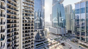 A modern high-rise building with multiple balconies and a unique cylindrical structure. - Staycae Holiday Homes - ZADA (Dubai)