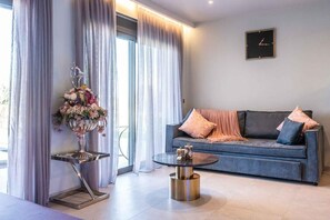 Exclusive Apartment, Partial Ocean View | Living area | 50-inch Smart TV with cable channels