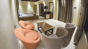A hotel room with a bed, a desk, a chair, and a sofa. - Anchor Eco Resort & Spa (Cox's Bazar)