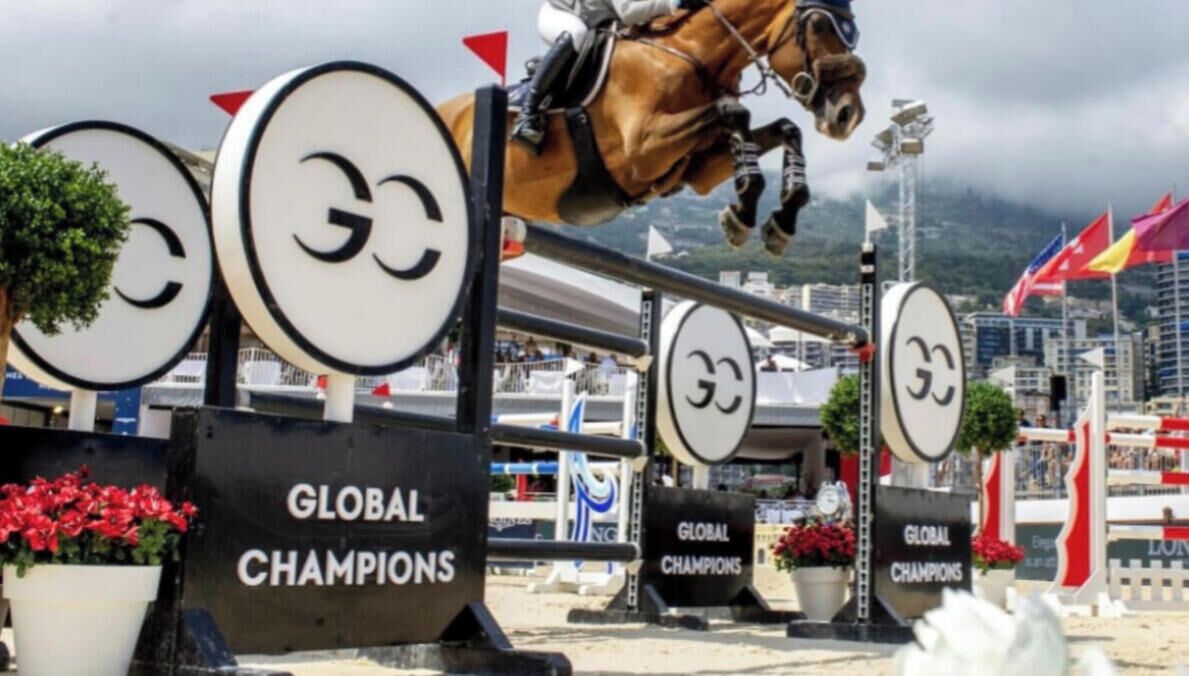 A horse jumping over a series of 'Global Champions' signs.