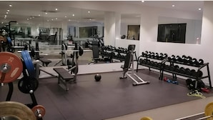 A gym with weightlifting equipment, treadmills, and exercise balls. - Embassy Gardens Cantonments Accra (Accra)