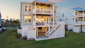 A two-story house with a balcony and a staircase leading to the upper floor. - Pet-Friendly Retreat with Hot Tub and Views (Port St. Joe)