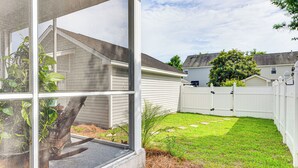 A backyard with a white fence, a small garden, and a house in the background. - 3 Mi to Beaches! Charming Bluffton Escape w/ Yard (Bluffton)