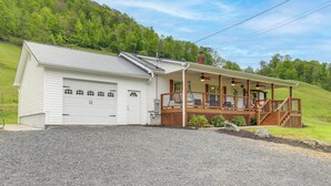A two-story house with a covered porch and a garage. - Hike & Relax: Blue Ridge Mountain Retreat! (Burnsville)
