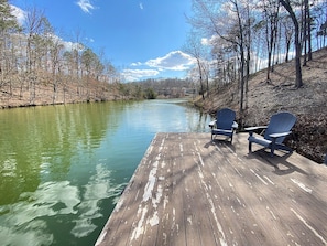 A wooden dock with two Adirondack chairs facing a calm river surrounded by trees. - Lakefront Cabin, Bella Vista Lake Rayburn Dock, MTB and family friendly (Bella Vista)
