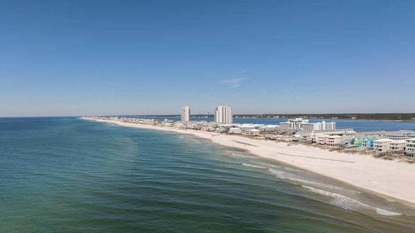 A coastal hotel with beachfront rooms, a sandy beach, and ocean views.
