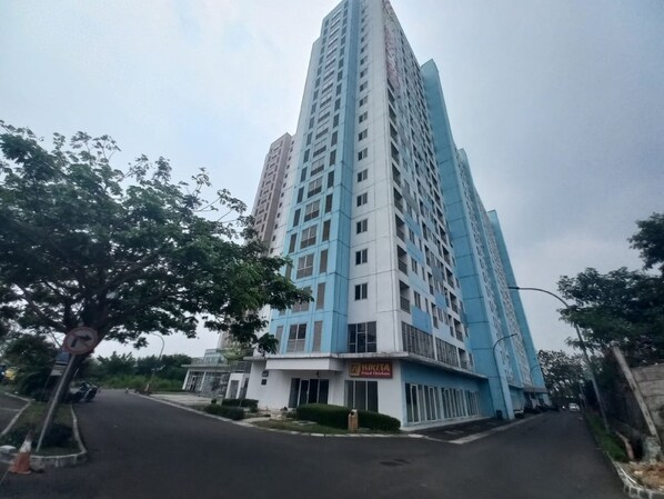 A tall residential building with a sign for 'Nikita Fried Chicken' on the ground floor.