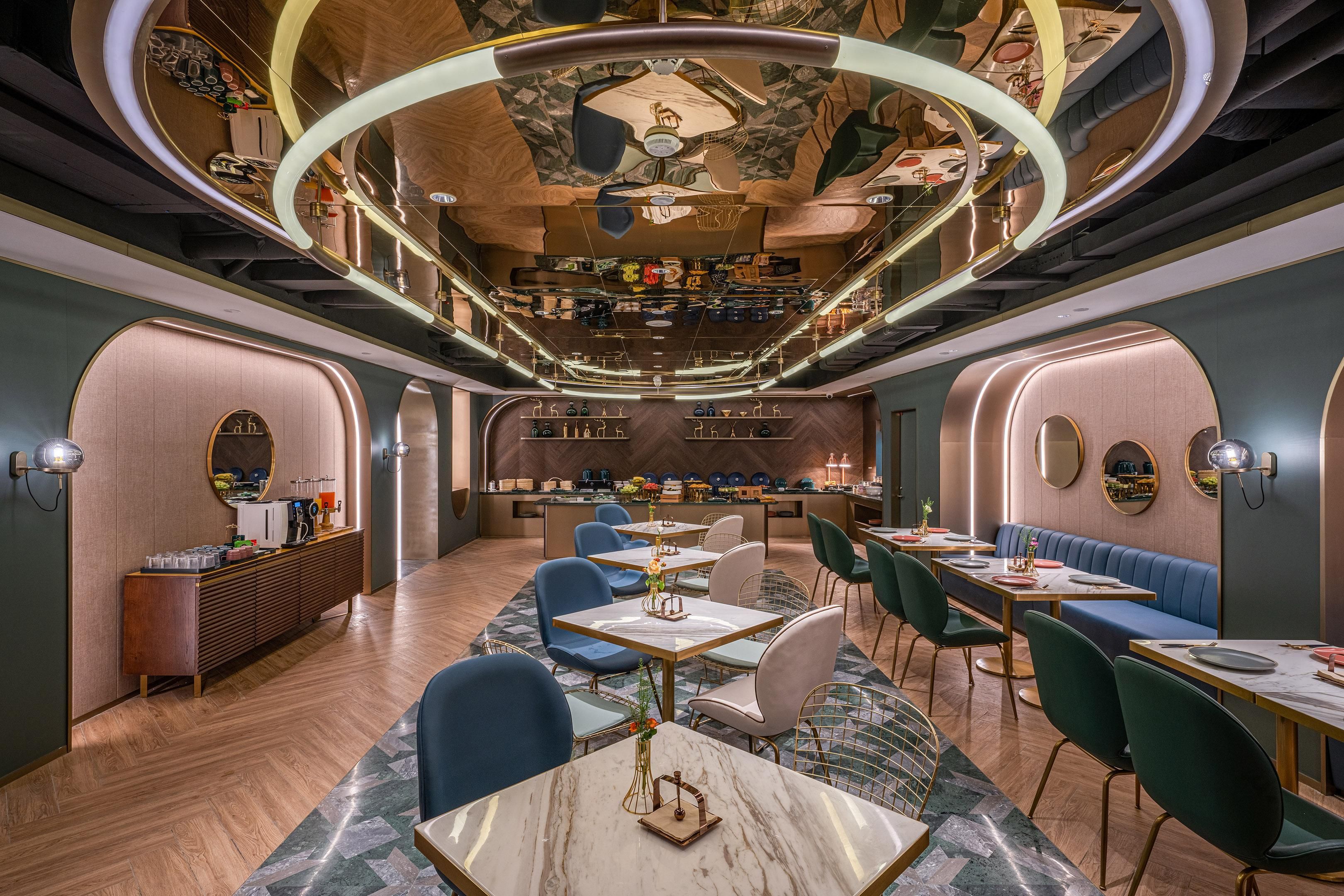 A modern interior with a bar area, seating, and a herringbone floor pattern.