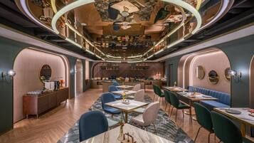 A modern interior with a bar area, seating, and a herringbone floor pattern.